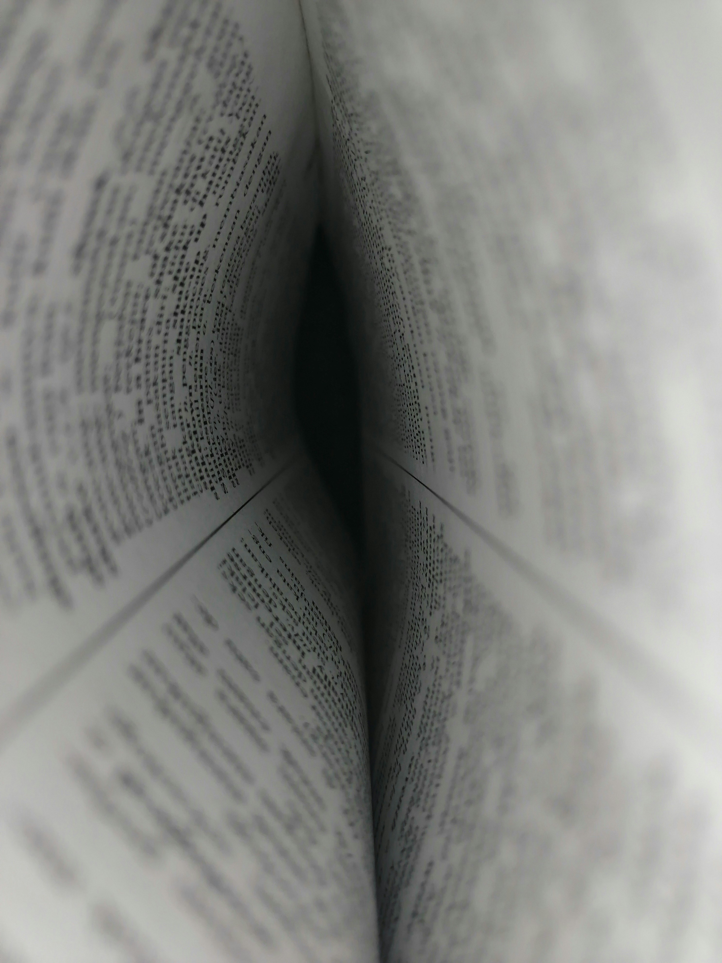 two pages of a book forming a kind of tunnel. The words are illegible